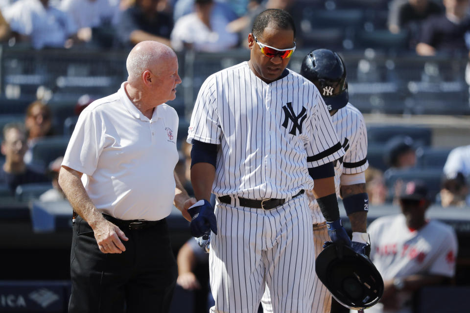 New York Yankees' Edwin Encarnacion is helped by trainer Steve Donohue after being hit by a pitch thrown by Boston Red Sox's Josh Smith during the eighth inning of a baseball game Saturday, Aug. 3, 2019, in New York. Encarnacion suffered a broken right wrist. (AP Photo/Michael Owens)
