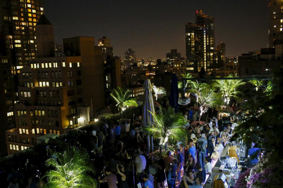 People watch from a roof as images are projected onto the Empire State Building as part of an endangered species projection to raise awareness, in New York August 1, 2015. (REUTERS/Eduardo Munoz)