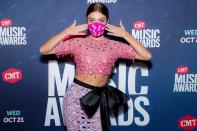 <p>Sarah Hyland sparkles in a colorful two-piece look and a mask emblazoned with the word 'Vote' at the CMT Awards on Wednesday in Nashville. </p>