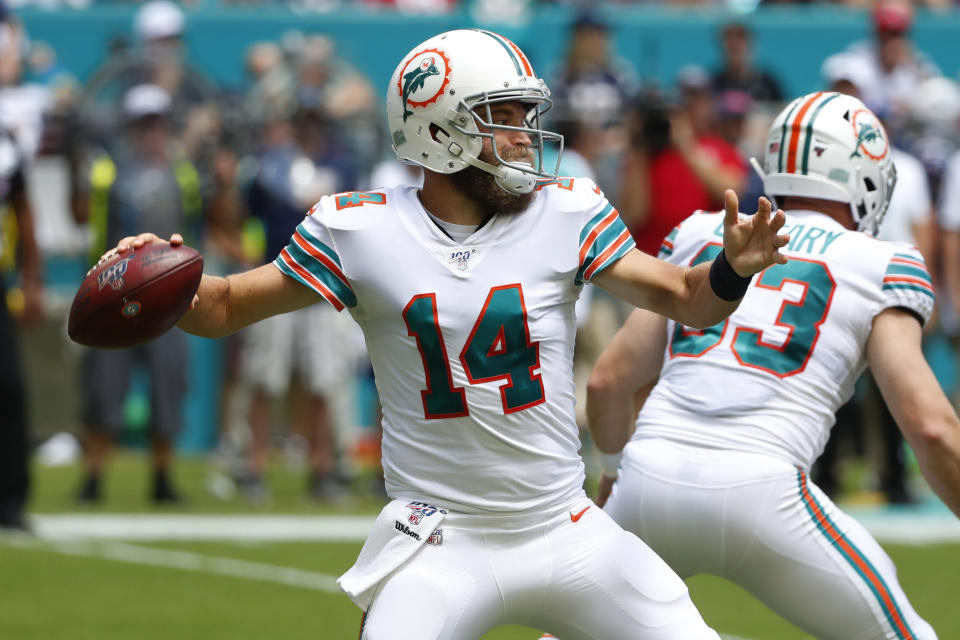 FILE - In this Sept. 15, 2019, file photo, Miami Dolphins quarterback Ryan Fitzpatrick (14) looks to pass during the first half at an NFL football game against the New England Patriots, in Miami Gardens, Fla. Ryan Fitzpatrick will start at quarterback Sunday for the winless Miami Dolphins at Buffalo, and Josh Rosen will be back on the bench. Coach Brian Flores announced the decision Wednesday, Oct. 16, 2019. (AP Photo/Wilfredo Lee, File)