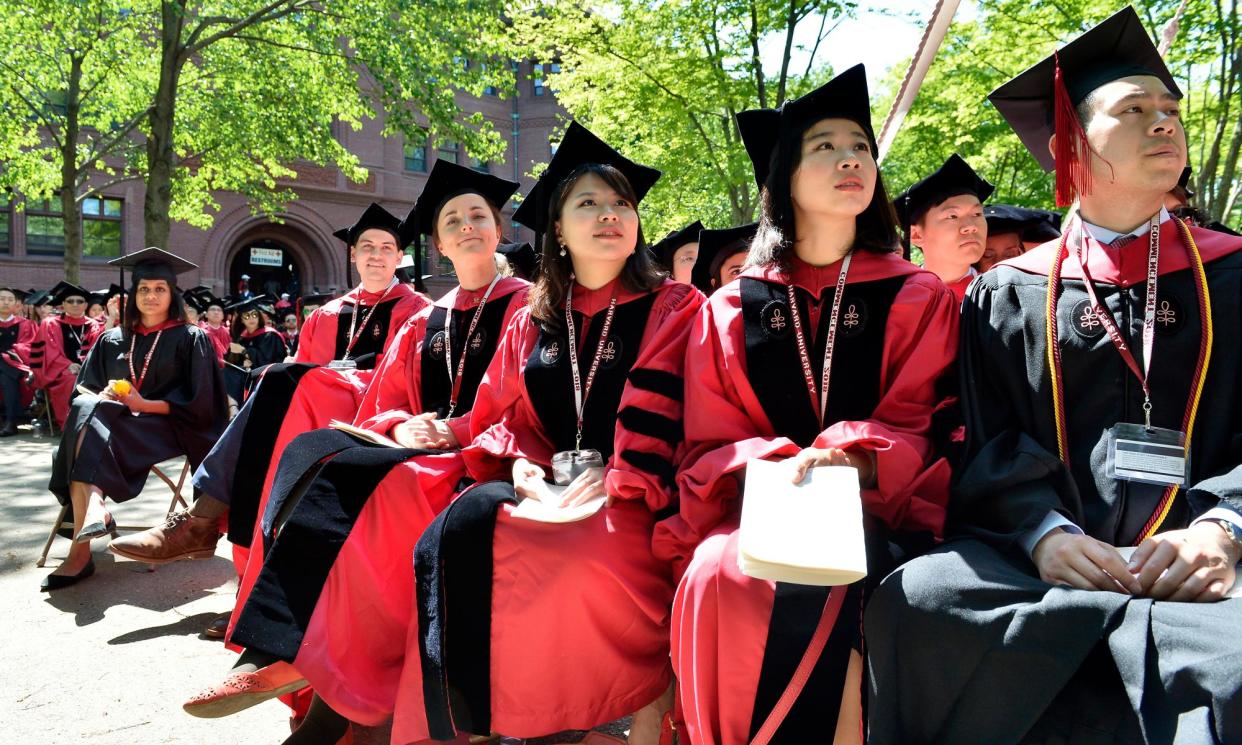 <span>Students at a degree ceremony at Harvard University in Massachusetts.</span><span>Photograph: Paul Marotta/Getty Images</span>