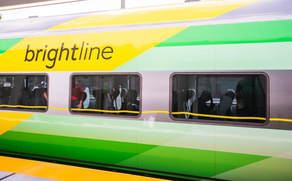 Passengers are seen sitting in a Brightline train parked at the new station on Tuesday, December 20, 2022, in Boca Raton, FL. Just one day short of a year since construction began at the site in Boca Raton, city and Brightline officials hosted a ribbon cutting ceremony ahead of the station opening to the public on December 21st. 