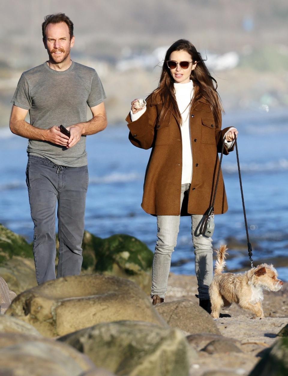 <p>Newly engaged couple Lily Collins and Charlie McDowell's new relationship is rock solid as they take their pup for a walk in Carpinteria, California on Monday. </p>