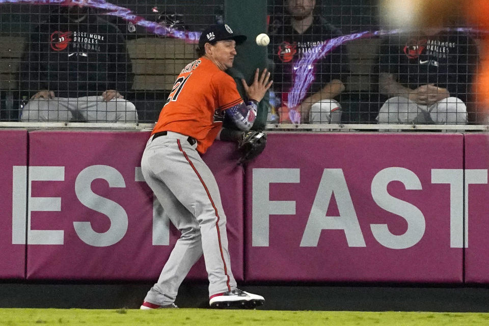 Baltimore Orioles left fielder Austin Hays collides with the wall as he tries to make a catch on a ball hit for a double by Los Angeles Angels' Jared Walsh during the fifth inning of a baseball game Saturday, July 3, 2021, in Anaheim, Calif. (AP Photo/Mark J. Terrill)