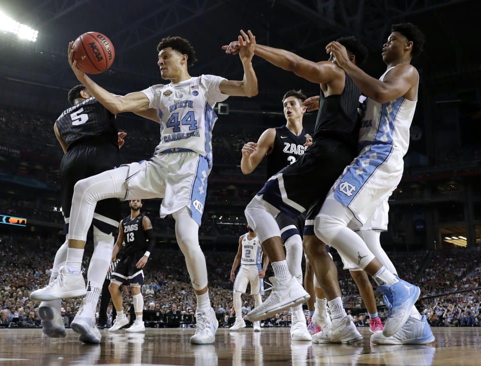 North Carolina forward Justin Jackson (44) grabs a rebound over Gonzaga guard Nigel Williams-Goss (5) during the first half in the finals of the Final Four NCAA college basketball tournament, Monday, April 3, 2017, in Glendale, Ariz. (AP Photo/Mark Humphrey)