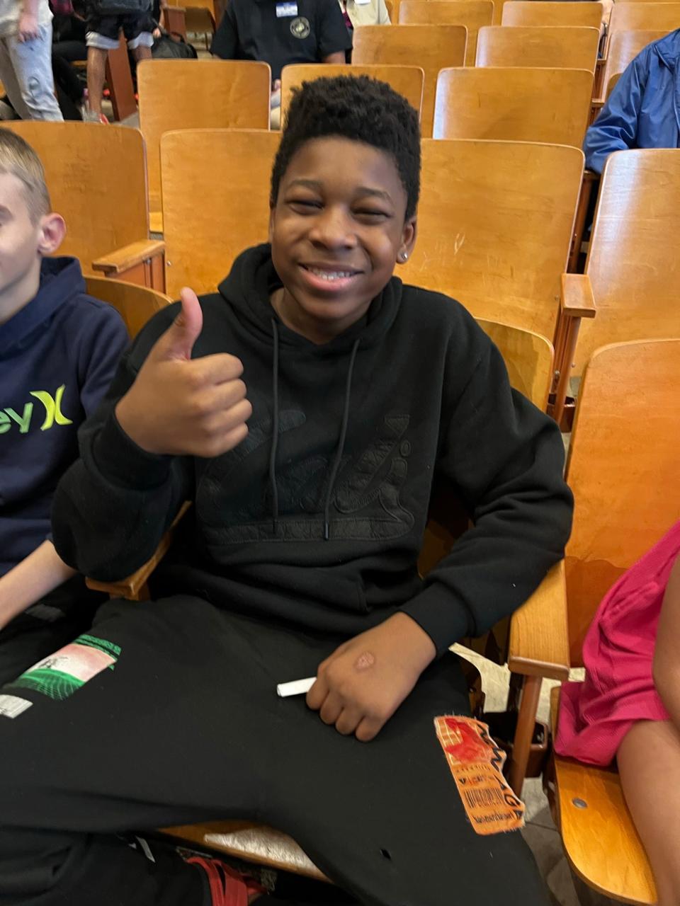 Mahki Nolan-Tatum gives a big thumbs up for Veterans Day. He’s part of the Gresham Middle School student teams that led the program from the stage when GMS presented its annual salute to veterans on Friday, Nov. 10, 2023