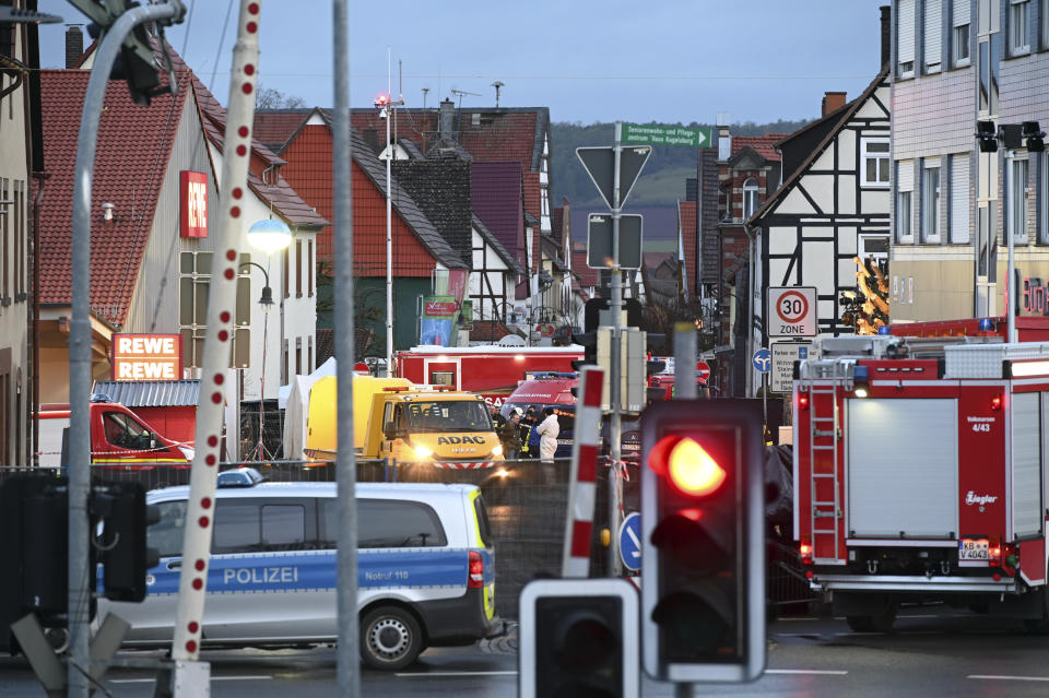 Emergency cars, police and fire brigade units standing at the scene after a man had driven his car into a carnival parade in Volkmarsen, Germany, Tuesday, Feb. 25, 2020. On Monday, Feb. 24, 2020 a man drives into a carnival parade in the central Geman city Volkmarsen and injured several people. (Uwe Zucchi/dpa via AP)