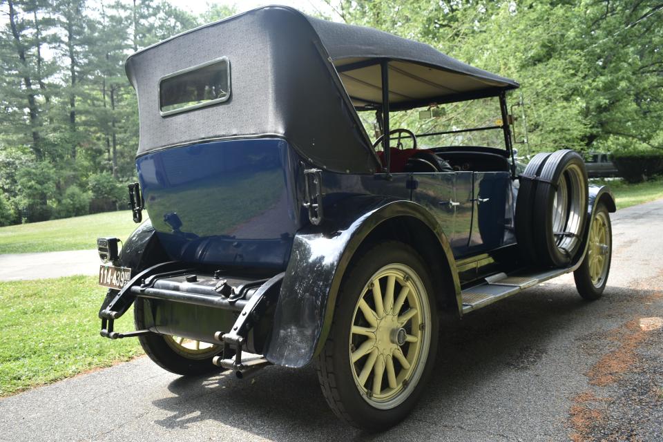 Tim Lloyd's all-original 1923 Hudson Speedster from the back. There are fabric panels with rectangular windows that can be attached to enclose the car's interior.