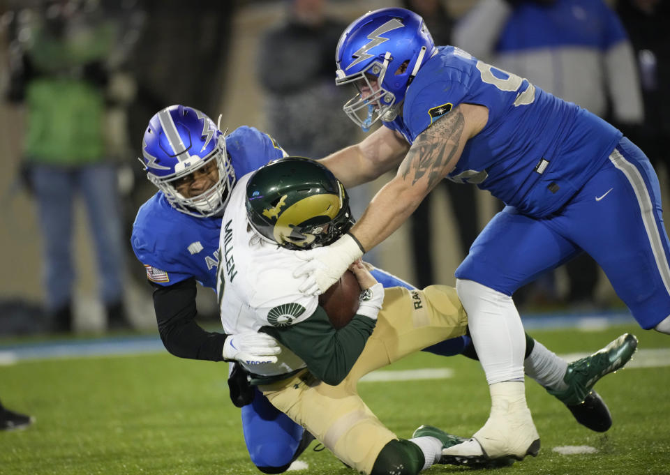 Colorado State quarterback Clay Millen, center, is sacked by Air Force linebacker Vince Sanford, left, and defensive lineman Peyton Zdroik during the second half of an NCAA college football game Saturday, Nov. 19, 2022, at Air Force Academy, Colo. (AP Photo/David Zalubowski)