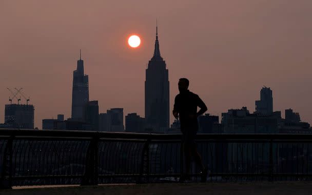 PHOTO: Haze from wildfires burning in eastern Canada, create a hazy sunrise over the New York City skyline, May 22, 2023. (Gary Hershorn)