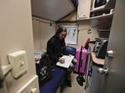 <p>Ringling Bros. clown Beth Walters writes in a journal in her living quarters on the circus’ train before heading off to the arena to perform in a show, Thursday, May 4, 2017, in Providence, R.I. Walters had taken down most of the photos and decorations in her room to prepare to move out and head home after the red unit’s final performance. (Photo: Julie Jacobson/AP) </p>