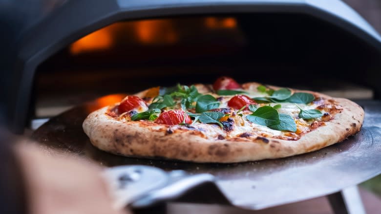 Baking pizza in outdoor oven