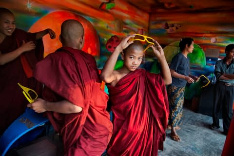 Novice monks at an amusement park in Mandalay - Credit: Steve McCurry