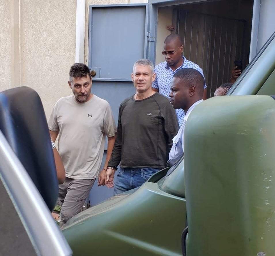 Robert Snyder, left, and Jonathan Lehrer arrive at a courthouse in Roseau, Dominica, where they were charged with the murders of Daniel Langlois and his partner Dominique Marchand. (EmoNews - image credit)