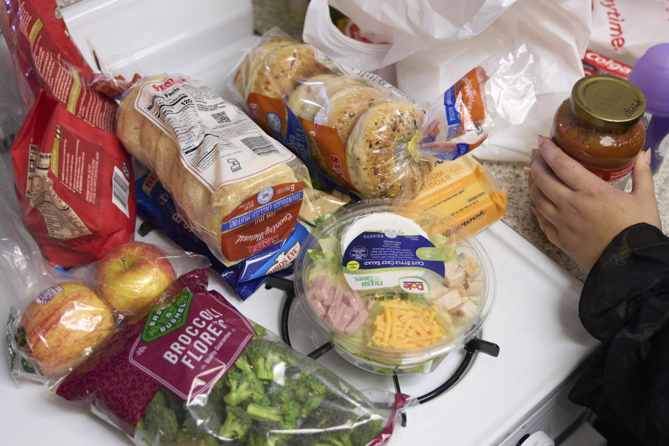 Groceries are displayed on a counter in Bellflower, Calif., on Monday, Feb. 13, 2023. Student and legal advocacy groups are petitioning the U.S. Department of Agriculture to lift the interview requirement for Supplemental Nutrition Assistance Program (SNAP) applicants to receive food aid. SNAP helps low-income families supplement their budgets so they can buy groceries, snacks, and non-alcoholic beverages. An estimated 42 million Americans currently receive the benefits at an average of $212 per person or $401 per household. (AP Photo/Allison Dinner, File)