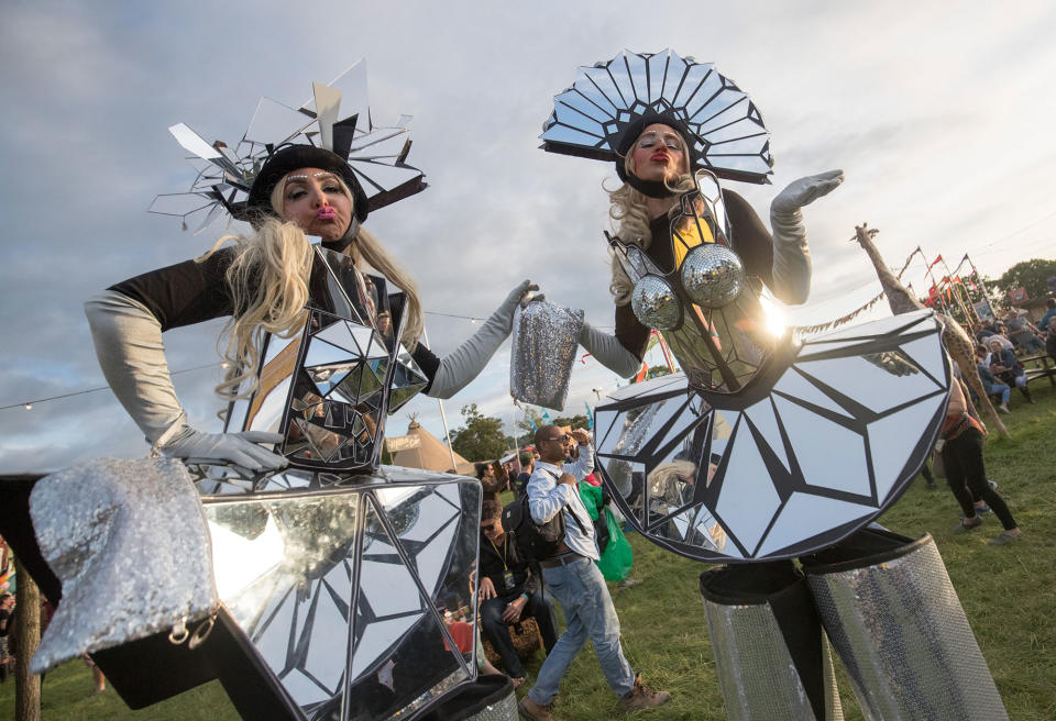 <p>Stilt walkers perform at the Glastonbury Festival site at Worthy Farm in Pilton on June 22, 2017 near Glastonbury, England. (Photo: Matt Cardy/Getty Images) </p>