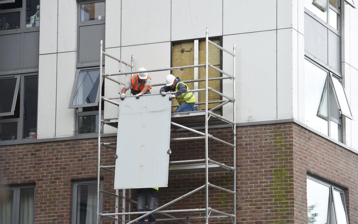 Cladding being removed from the Burnham house Tower on the Chalcot Estate - Evening Standard / eyevine