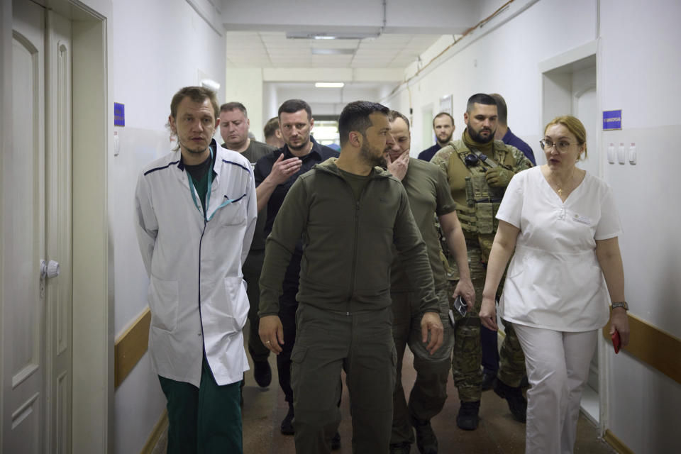 In this photo provided by the Ukrainian Presidential Press Office, Ukrainian President Volodymyr Zelenskyy visits a city hospital with people suffering from flooding in Kherson, Ukraine, Thursday, June 8, 2023. (Ukrainian Presidential Press Office via AP)
