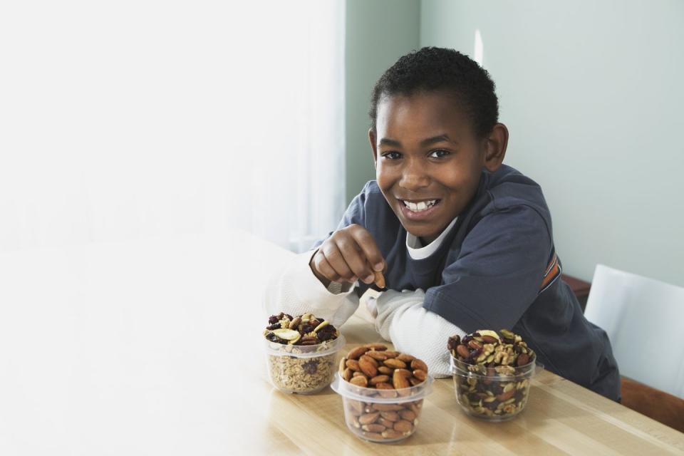 smiling boy eating nuts fun activities for kids