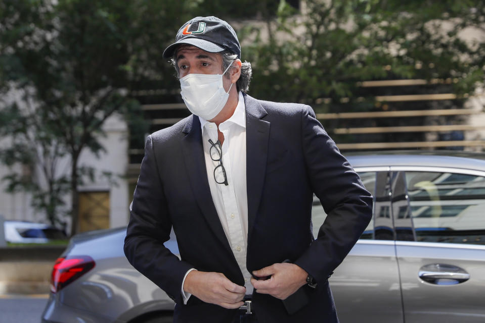 FILE- In this May 21, 2020 file photo, Michael Cohen arrives at his Manhattan apartment in New York after being furloughed from prison because of concerns over the coronavirus. A judge ordered the release from prison, Thursday, July 23 of President Donald Trump's former personal lawyer, saying he believes the government retaliated against him for writing a book about Trump. Cohen sued federal prison officials including Attorney General William Barr on Monday, July 20 saying he was returned to an Otisville, New York, prison to stop him from publishing a tell-all book about his experiences with Trump. (AP Photo/John Minchillo, File)