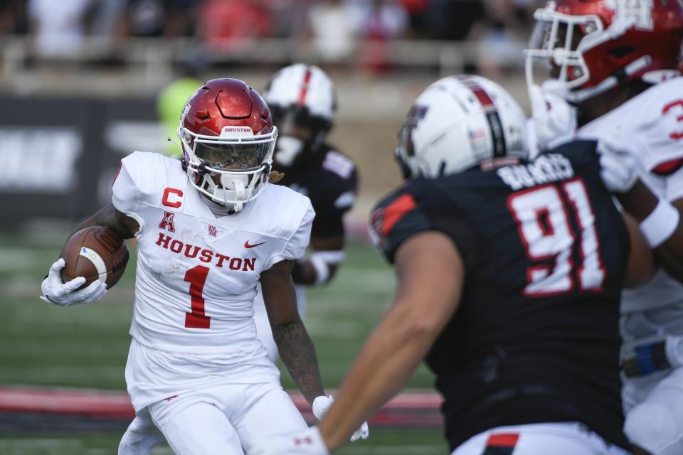 CORRECTS CITY TO IN LUBBOCK, TEXAS - Houston wide receiver Nathaniel Dell (1) runs the ball against Texas Tech during the first half of an NCAA college football game Saturday, Sept. 10, 2022, in Lubbock, Texas. (AP Photo/Justin Rex)