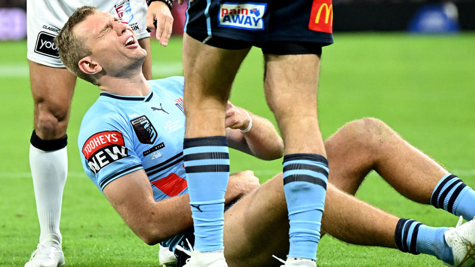 Seen here, Tom Trbojevic goes down injured in Origin Game II.