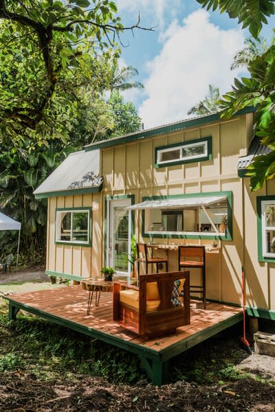 The first build by Paradis Tiny Homes, the Oasis model is a 260-square-foot, wood framed house that makes continual use of curves: from the bump-out window in the living room, through the corrugated metal roof and the exposed beams beneath them, to the bend of the inside stair.