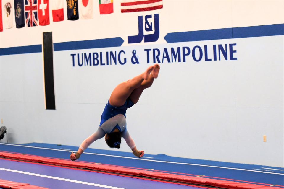 Sarah Thompson flips around during one of her tumbling passes while practicing at J&J Tumbling and Trampoline in Pecatonica.