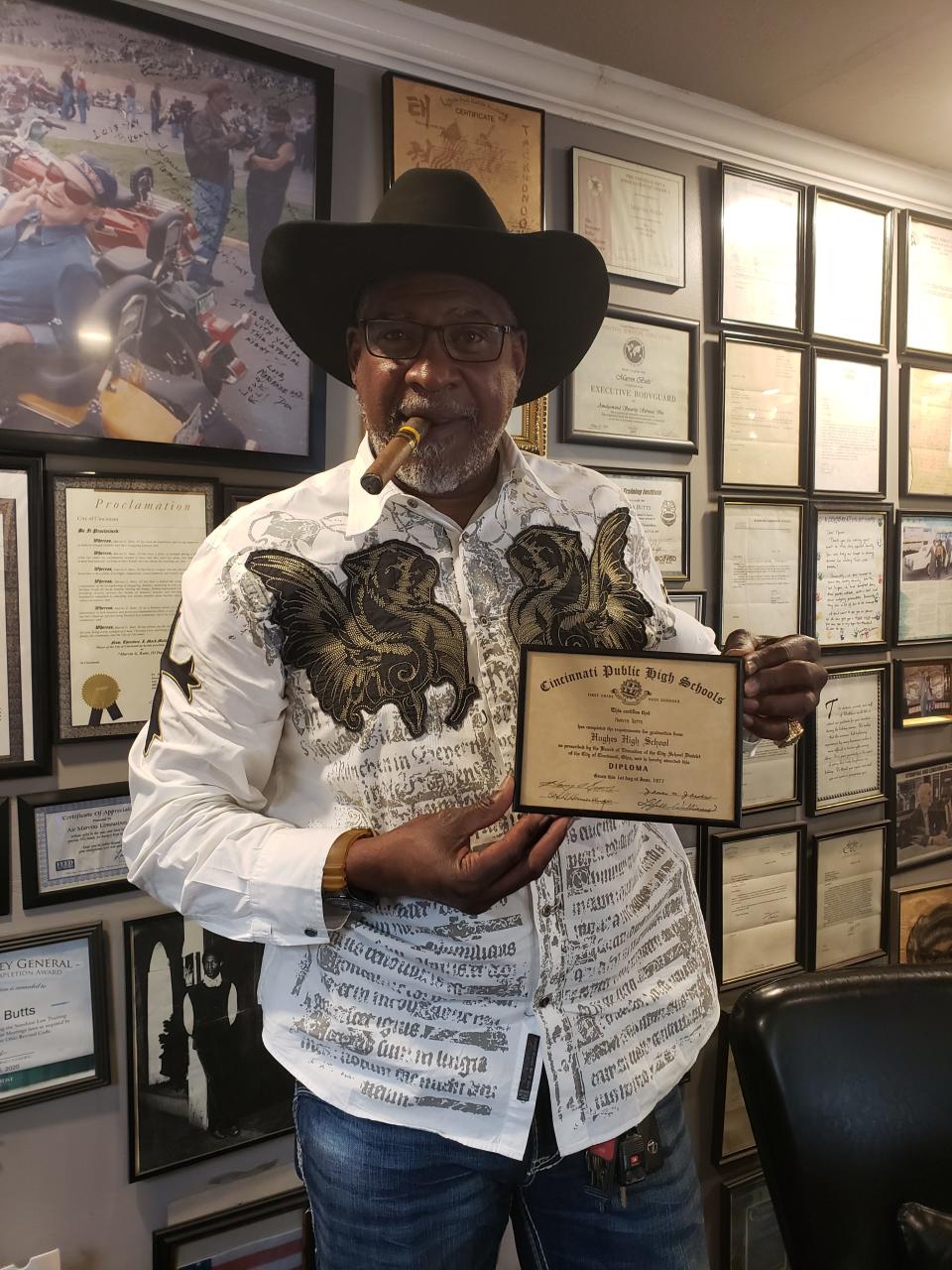 Marvin Butts, owner of Mr. Bubbles Detailing in Pendleton and founder of the Butts Family Foundation, holds his diploma from Hughes High School in his office on Monday, May 8, 2023. The Butts Family Foundation raised thousands of dollars to pay outstanding fees for roughly 300 students at five Cincinnati Public Schools high schools so their diplomas and transcripts would not be withheld.