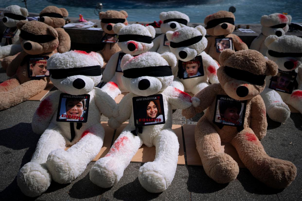 Tel Aviv: An installation of blindfolded giant teddy bears adorned with photos of Israeli children held captive in Gaza (AP)