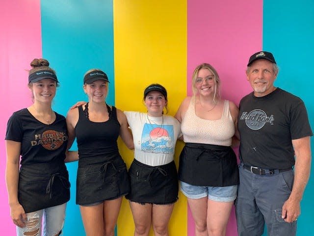 Carriage House Creamery employees Cialah Arnold, Mia Gaetjens, and Kayleigha Dempsey pose with manager Lexi Vance and her father Bill Vance.