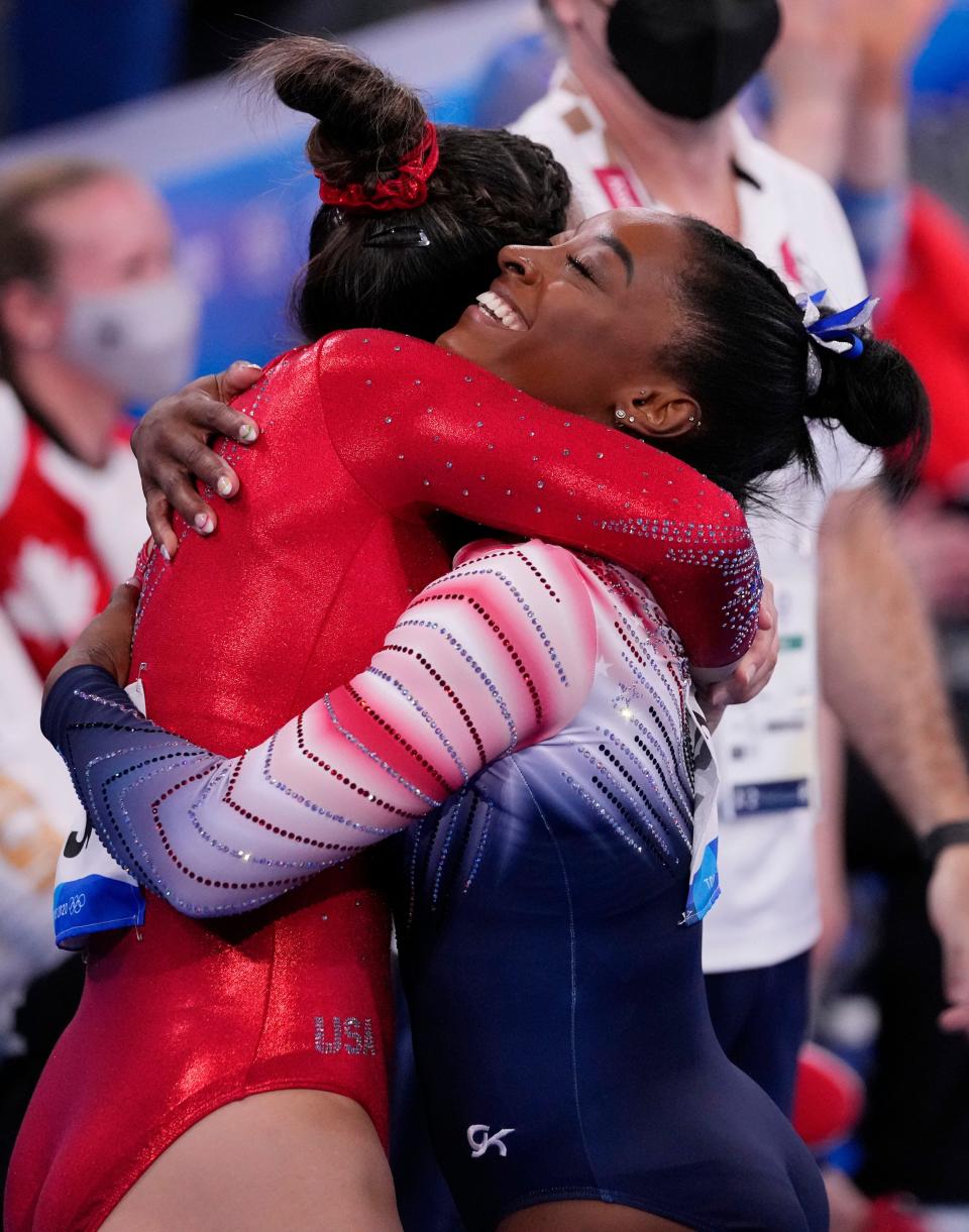 Simone Biles hugs teammate Sunisa Lee after Biles competed on balance beam.
