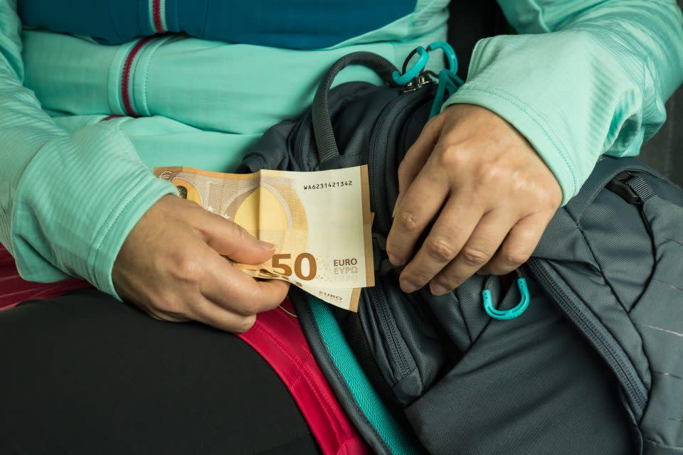 person taking euros out of their bags 