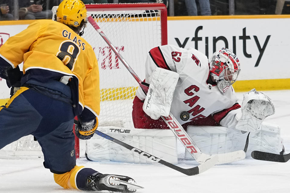 Carolina Hurricanes goaltender Pyotr Kochetkov (52) blocks a shot on goal by Nashville Predators center Cody Glass (8) during the second period of an NHL hockey game Wednesday, Dec. 27, 2023, in Nashville, Tenn. (AP Photo/George Walker IV)