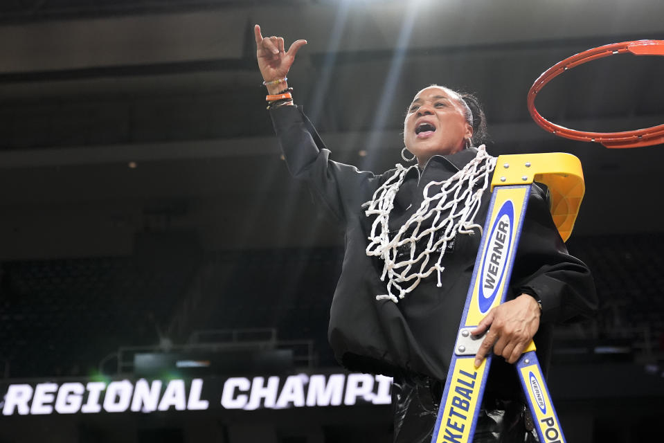 FILE - South Carolina head coach Dawn Staley celebrates after cutting down the net after defeating Oregon State in an Elite Eight round college basketball game during the NCAA Tournament, Sunday, March 31, 2024, in Albany, N.Y. Staley was honored Thursday, April 4, as The Associated Press women’s college basketball Coach of the Year for the second time.(AP Photo/Mary Altaffer, File)