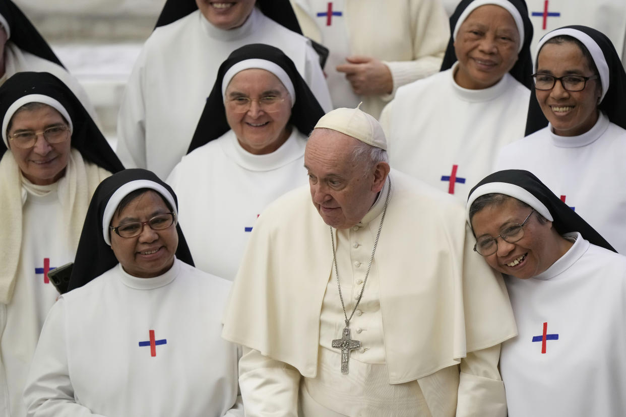 Pope Francis poses for a photo with a group of nuns at the end of his weekly general audience in the Pope Paul VI hall at the Vatican, Wednesday, Jan. 4, 2023. (AP Photo/Andrew Medichini)