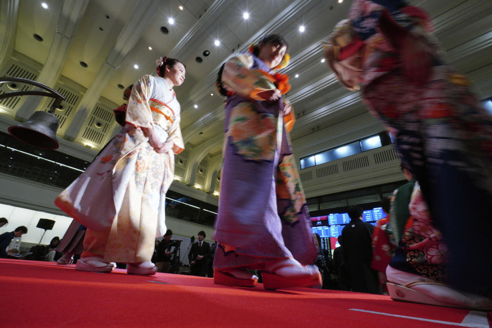 Kimono-clad employees of the Tokyo Stock Exchange and models walk out from the stage during a ceremony marking the start of this year's trading in Tokyo Monday, Jan. 6, 2020, in Tokyo. (AP Photo/Eugene Hoshiko)