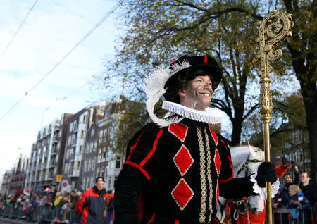 "Zwarte Piet" (Black Pete), who is a Saint Nicholas' assistant is seen during a traditional parade in Amsterdam, Netherlands, November 18, 2018. REUTERS/Eva Plevier