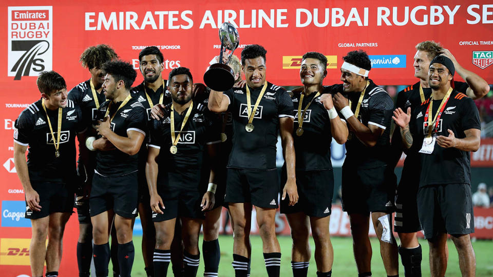 New Zealand celebrate with the trophy after winning the Emirates Airline Dubai Sevens. (Photo by Francois Nel/Getty Images)