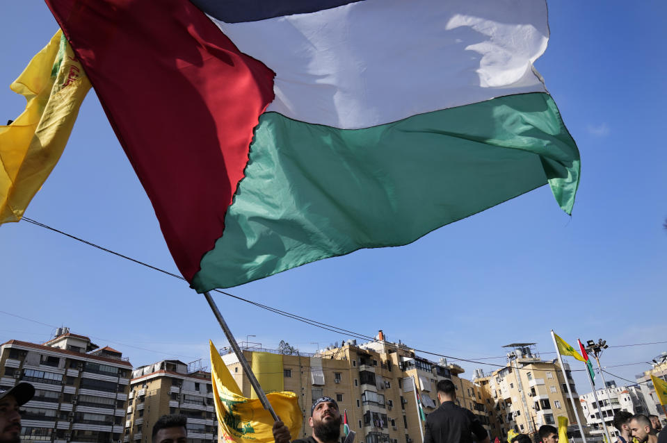 A supporter of the Iranian-backed Hezbollah group waves a Palestinian flag, as he waits the speech of Hezbollah leader Sayyed Hassan Nasrallah, during a rally to commemorate Hezbollah fighters who were killed in South Lebanon last few weeks while fighting against the Israeli forces, in Beirut, Lebanon, Friday, Nov. 3, 2023. Nasrallah's speech had been widely anticipated throughout the region as a sign of whether the Israel-Hamas conflict would spiral into a regional war. (AP Photo/Hussein Malla)