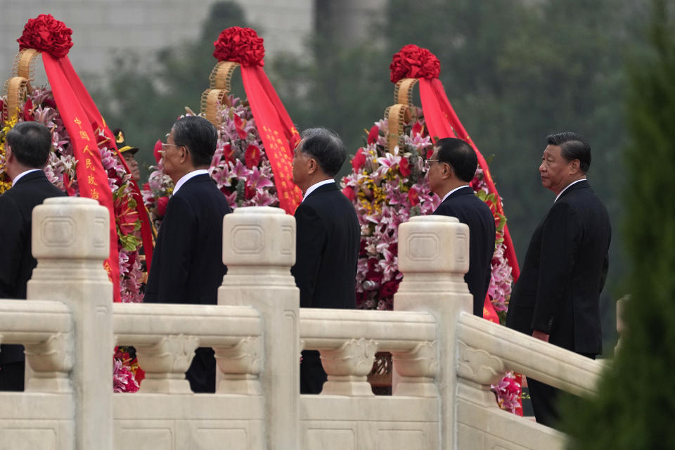 FILE - Chinese President Xi Jinping, right, looks as he and other members of the Chinese Politburo Standing Committee including Chinese Premier Li Keqiang, second from right, visit the Monument to the People's Heroes during a ceremony to mark Martyr's Day at Tiananmen Square in Beijing, Sept. 30, 2021. President Xi has been absent from the Group of 20 summit in Rome and global climate talks in Scotland, drawing criticism from U.S. President Joe Biden and questions about China's commitment to reducing greenhouse gas emissions. (AP Photo/Andy Wong, File)