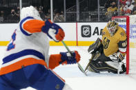 Vegas Golden Knights goalie Robin Lehner (90) makes a save against New York Islanders left wing Zach Parise in the first period during an NHL hockey game, Sunday, Oct. 24, 2021, in Las Vegas. (AP Photo/Rick Scuteri)