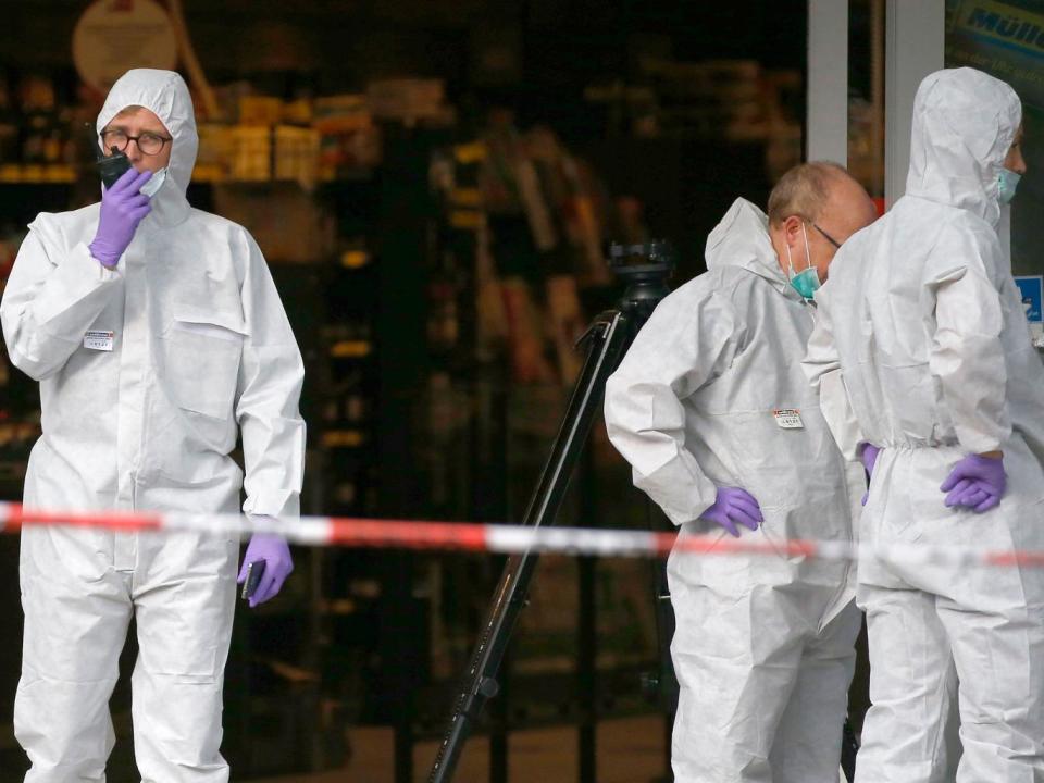 Forenics officers at the scene of the attack in on 28 July (Reuters)