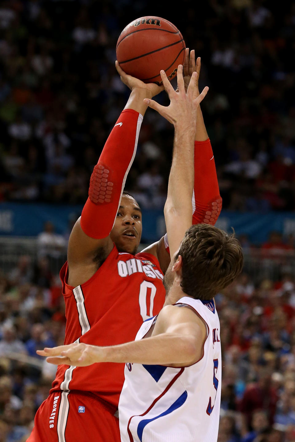 NEW ORLEANS, LA - MARCH 31: Jared Sullinger #0 of the Ohio State Buckeyes shoots over Jeff Withey #5 of the Kansas Jayhawks in the first half during the National Semifinal game of the 2012 NCAA Division I Men's Basketball Championship at the Mercedes-Benz Superdome on March 31, 2012 in New Orleans, Louisiana. (Photo by Jeff Gross/Getty Images)