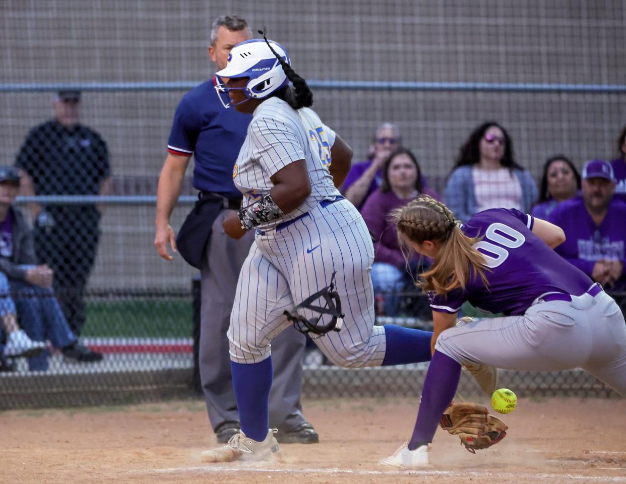 Pflugerville's Lauryn Jackson scores the Panthers' first run as Elgin pitcher Jessica Cantrell can't make the tag at home plate during the Panthers' 5-0 win Tuesday night. The victory moved Pflugerville into a tie for second place in District 23-5A.