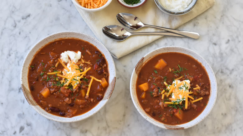 bowls of chili and toppings