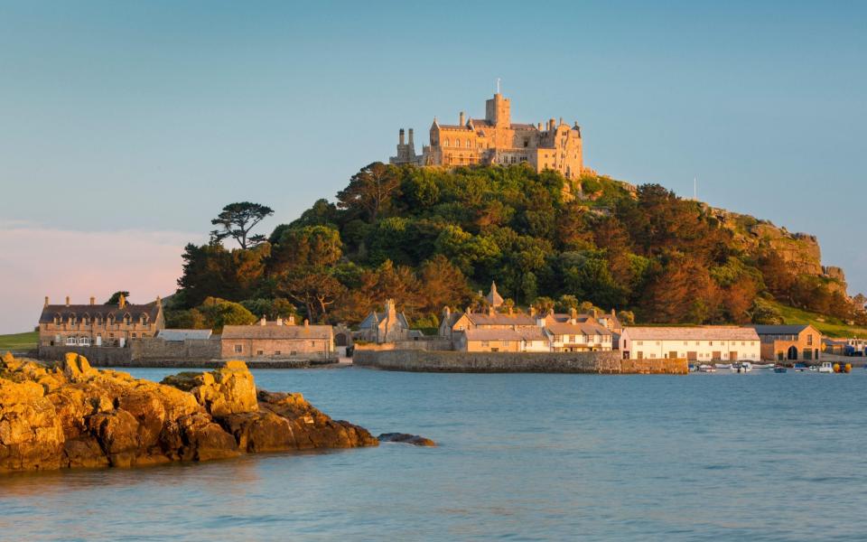 Setting sunlight on Saint Michael's Mount, Marazion, Cornwall, England - Getty