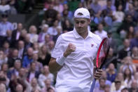 John Isner of the US celebrates winning a point against Britain's Andy Murray during their singles tennis match on day three of the Wimbledon tennis championships in London, Wednesday, June 29, 2022. (AP Photo/Alastair Grant)