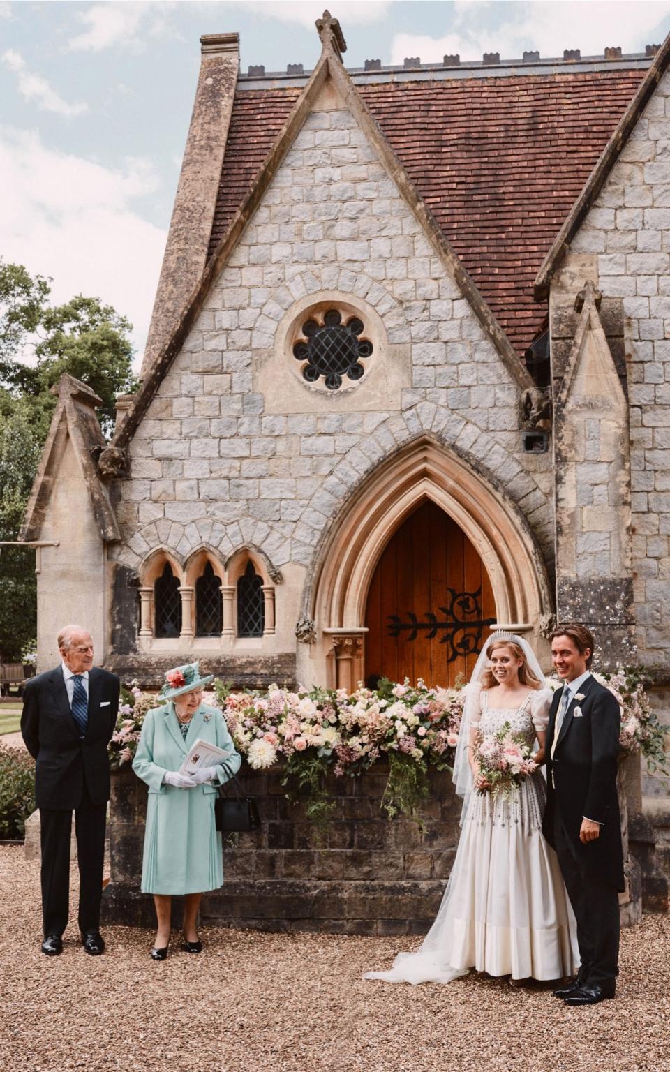 Queen Elizabeth and Prince Philip standing along with Princess Beatrice and Edoardo Mapelli Mozzi outside The Royal Chapel of All Saints at Royal Lodge, Windsor, after their wedding - Benjamin Wheeler