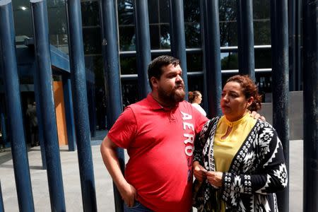 FILE PHOTO: Frida Urtiz, wife of reporter Salvador Adame Pardo, and his brother in law Franco Urtiz, stand during a protest for last May 18 disappearance of Adame, outside the offices of the Attorney General of the Republic in Mexico City, Mexico June 1, 2017. REUTERS/Carlos Jasso/File Photo